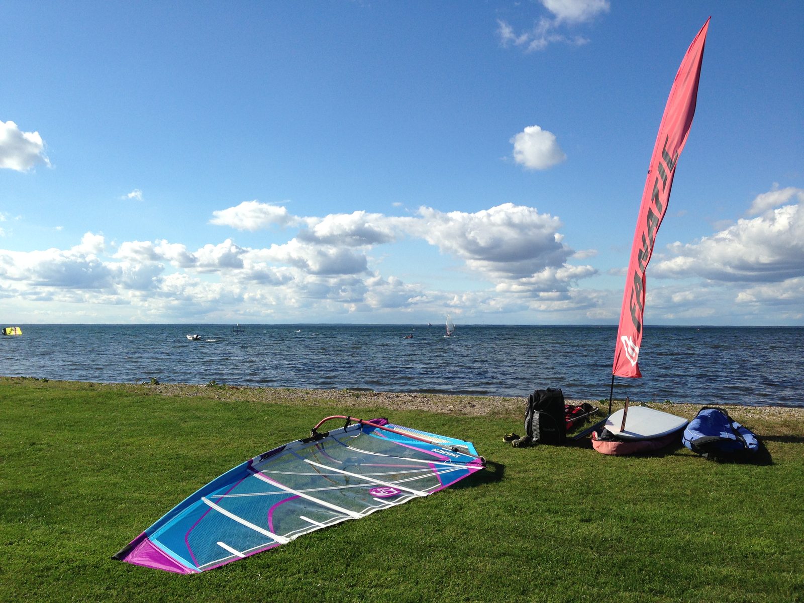 Windsurf boards lined up on the grass by the sea at Haga Park